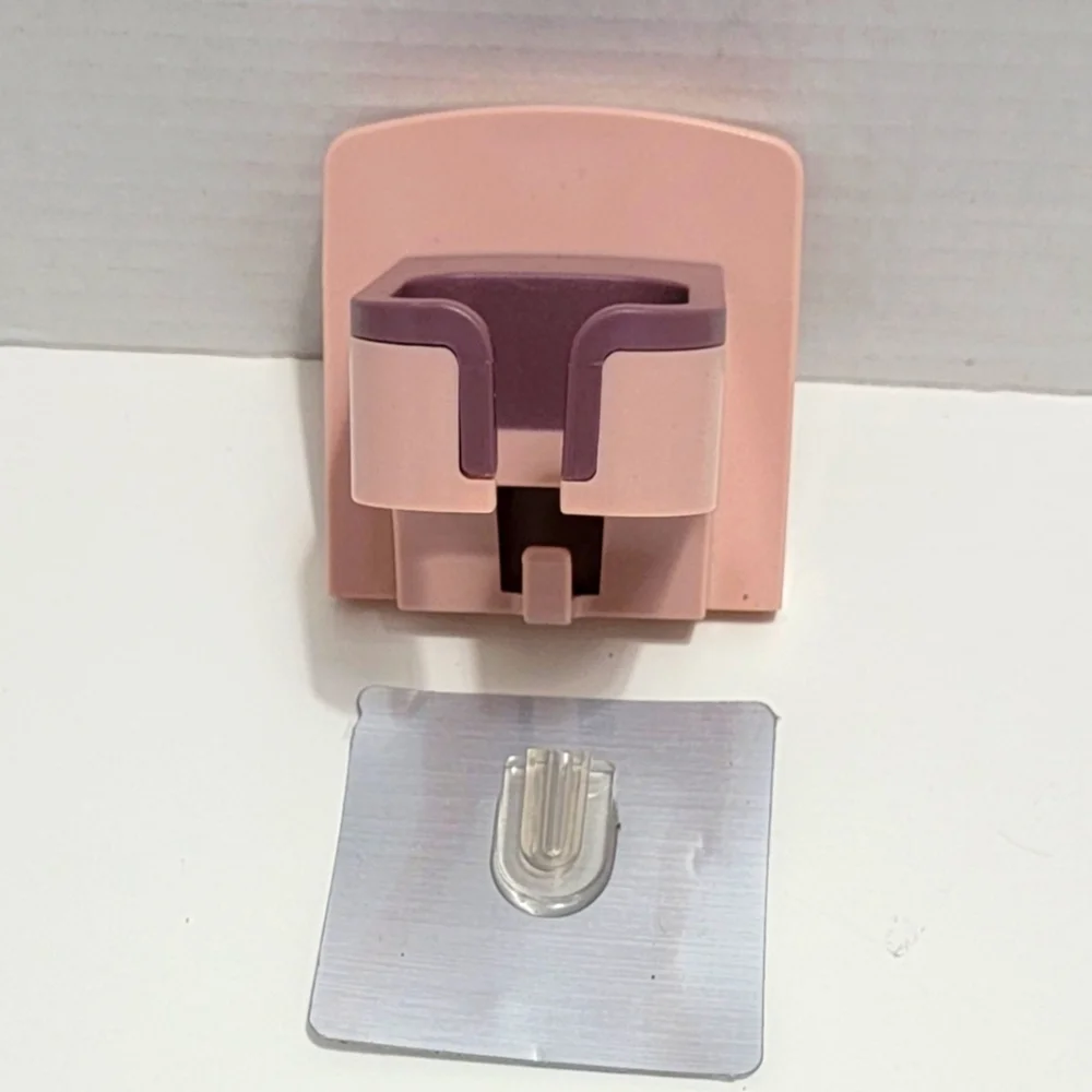 Pink and Purple Wall-Mounted Blow Dryer Holder.